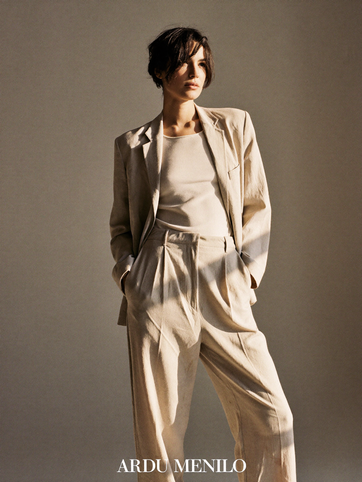 Arlisse editorial, woman in a tailored sand-beige linen set